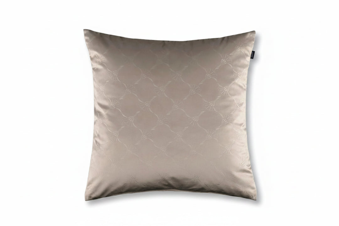 A square decorative throw pillow in a light taupe-beige color with a subtle tonal geometric lattice pattern, shown against a solid off-white background.