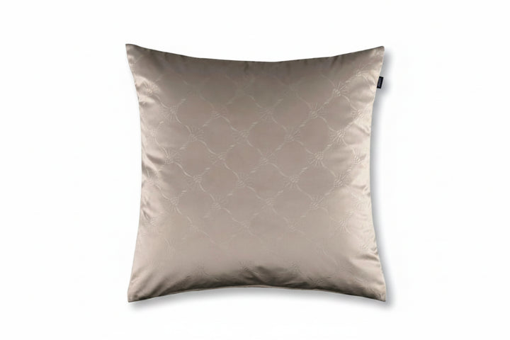 A square decorative throw pillow in a light taupe-beige color with a subtle tonal geometric lattice pattern, shown against a solid off-white background.
